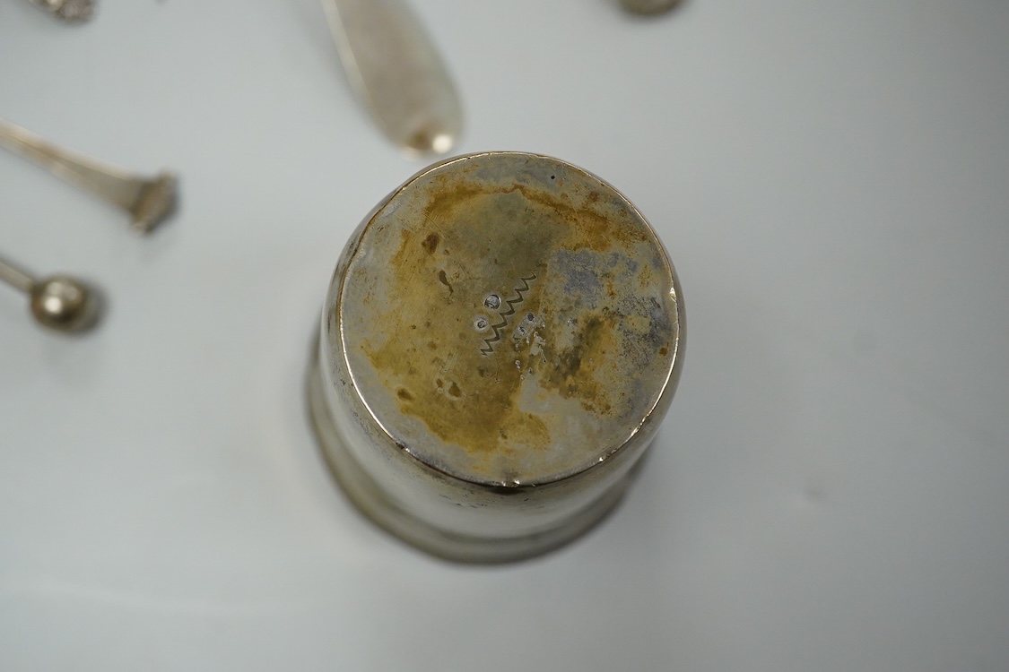 A continental white metal beaker, 69mm, five late Victorian silver coffee spoons, a silver pusher and butter knife and three white metal items.